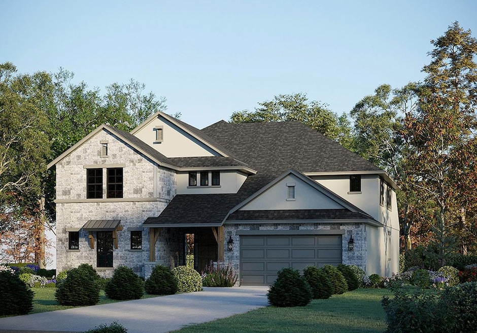 View of front of house with stone siding, drivewa