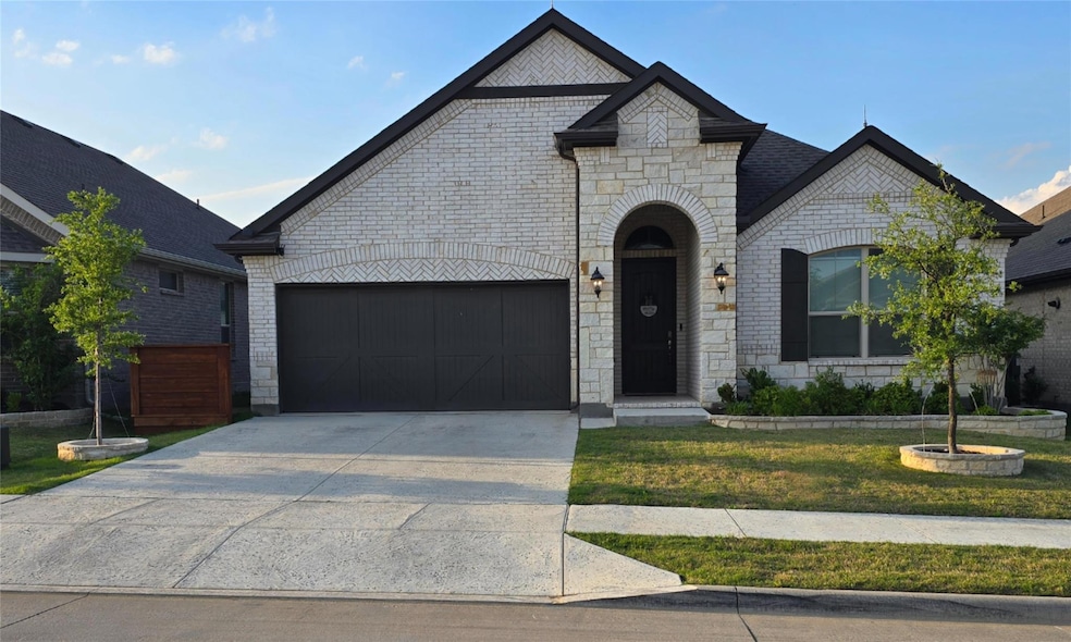 French country style house featuring brick siding,