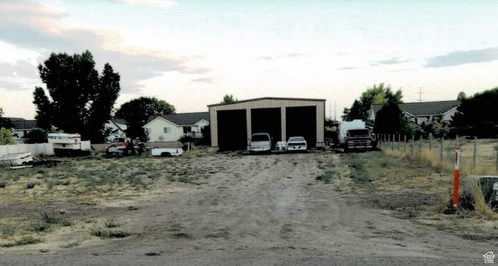 View of yard featuring an outdoor structure and a detached garage