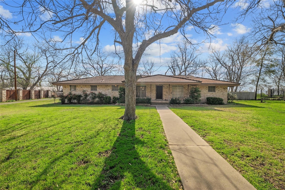 View of front of house featuring a tiled roof, a 