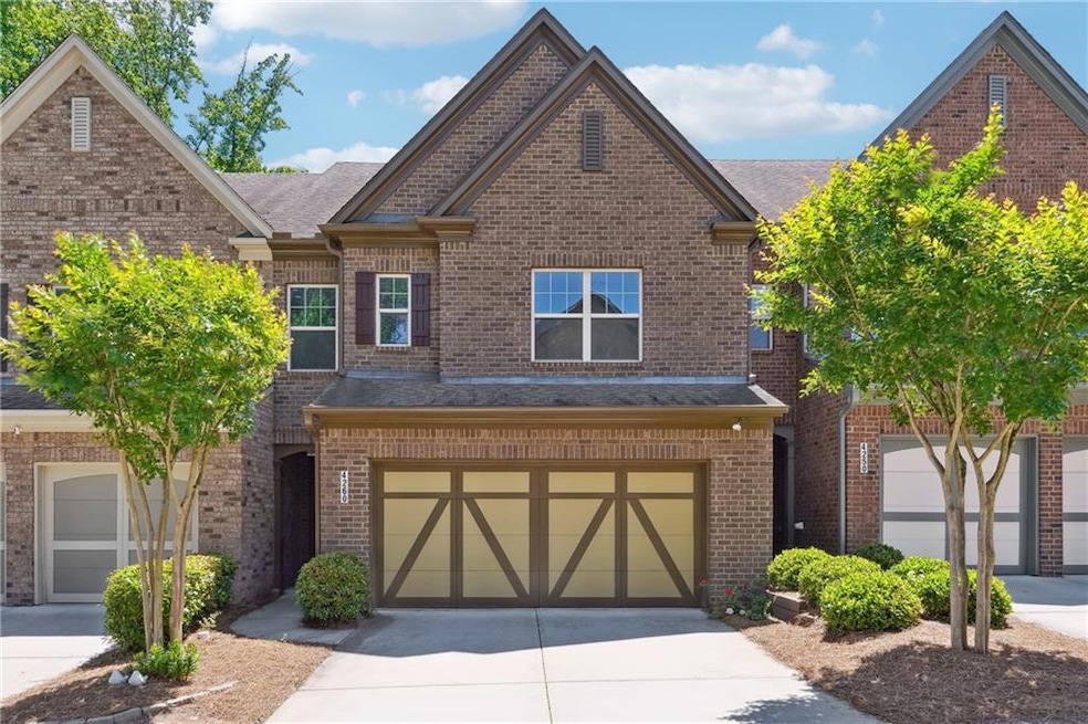 View of front of property with driveway, brick sid