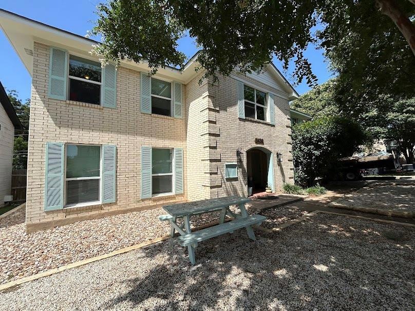Back of house featuring brick siding