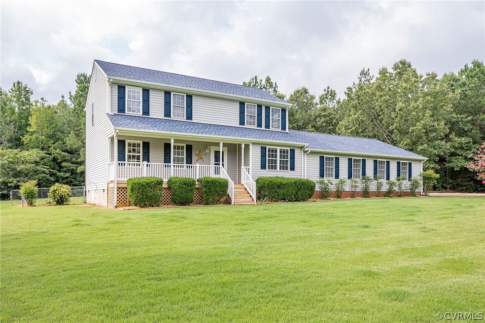 Colonial-style house with a front yard and covered