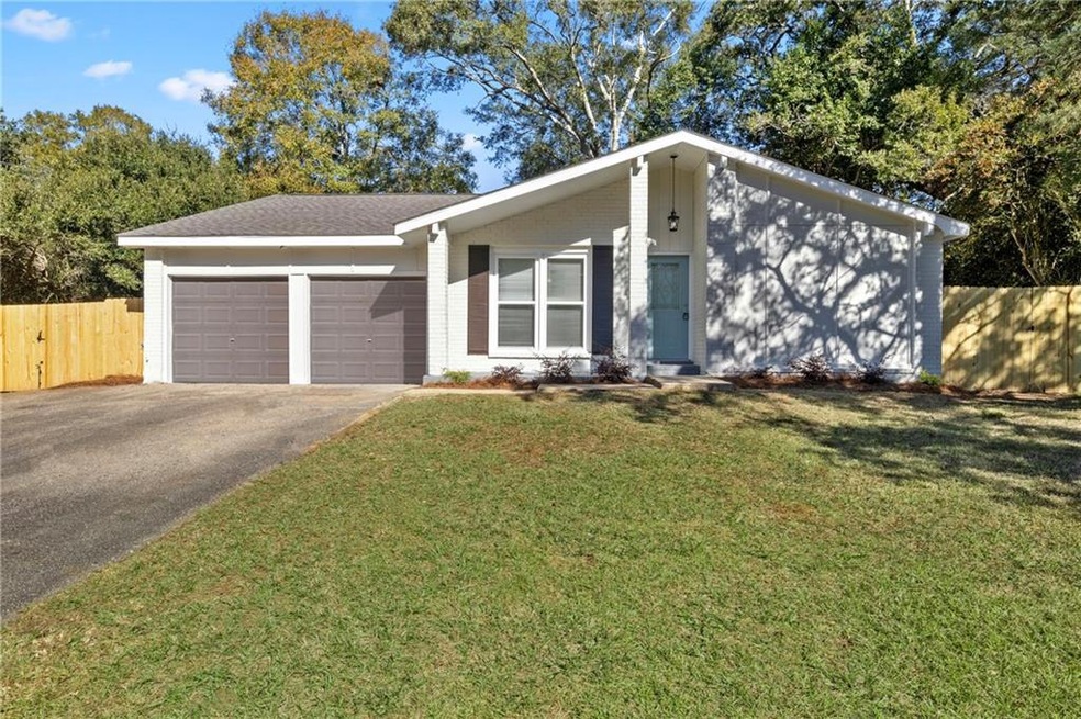Ranch-style house with a garage and a front lawn