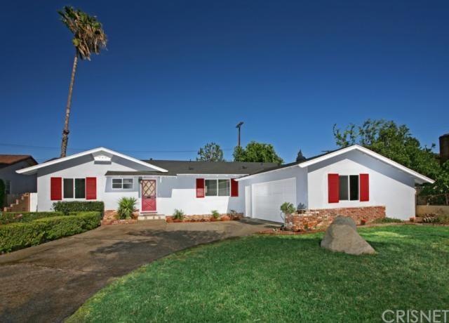 Lush green lawn, mature well- manicured hedges, abundant roses and brick flowerbeds offer eye-catching curb appeal.