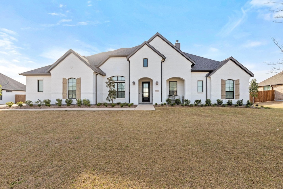 French provincial home featuring a front yard, fen