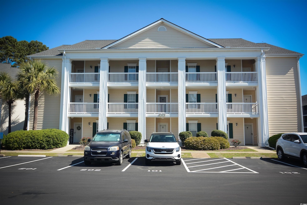 View of property with uncovered parking