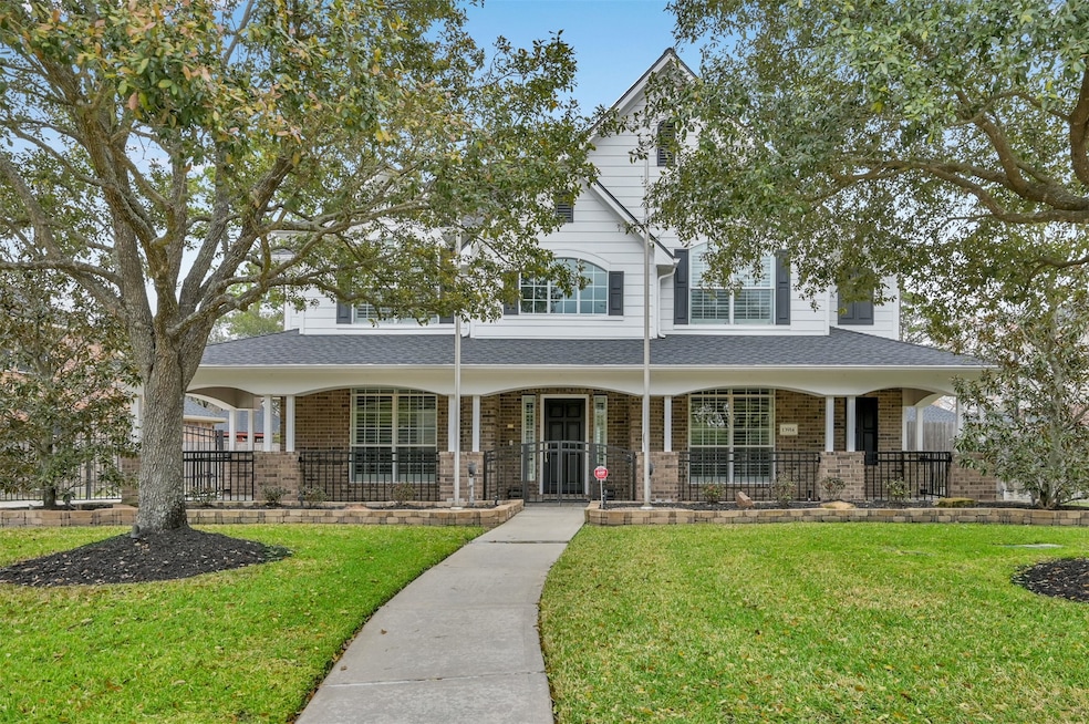 Front view with wrought iron fencing and automatic driveway gate.