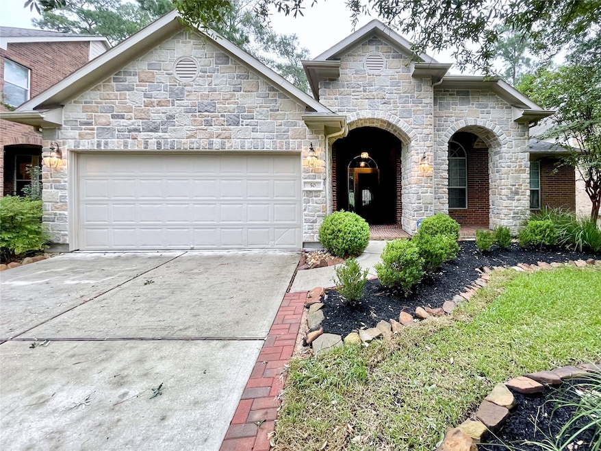 Charming single-story home with a stone façade, fe