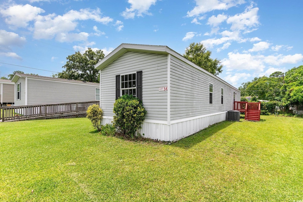 View of side of property with a lawn and central A