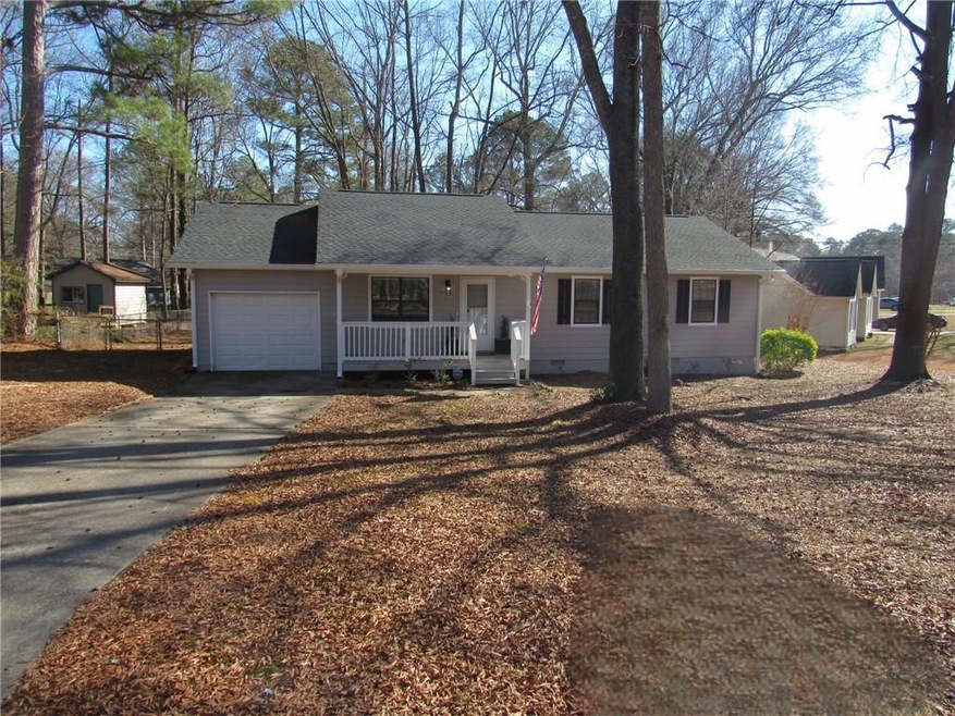 Ranch-style house with a garage and a porch