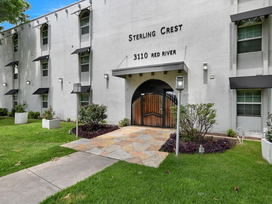 Entrance to property featuring a yard, a gate, an