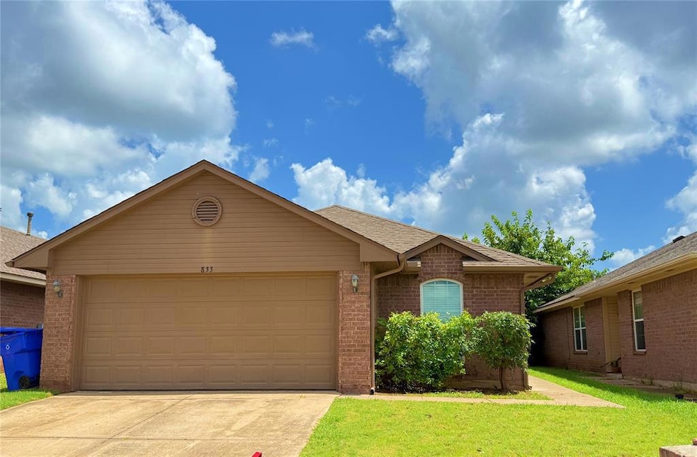 Single story home featuring driveway, an attached garage, a front lawn, brick siding, and roof with shingles