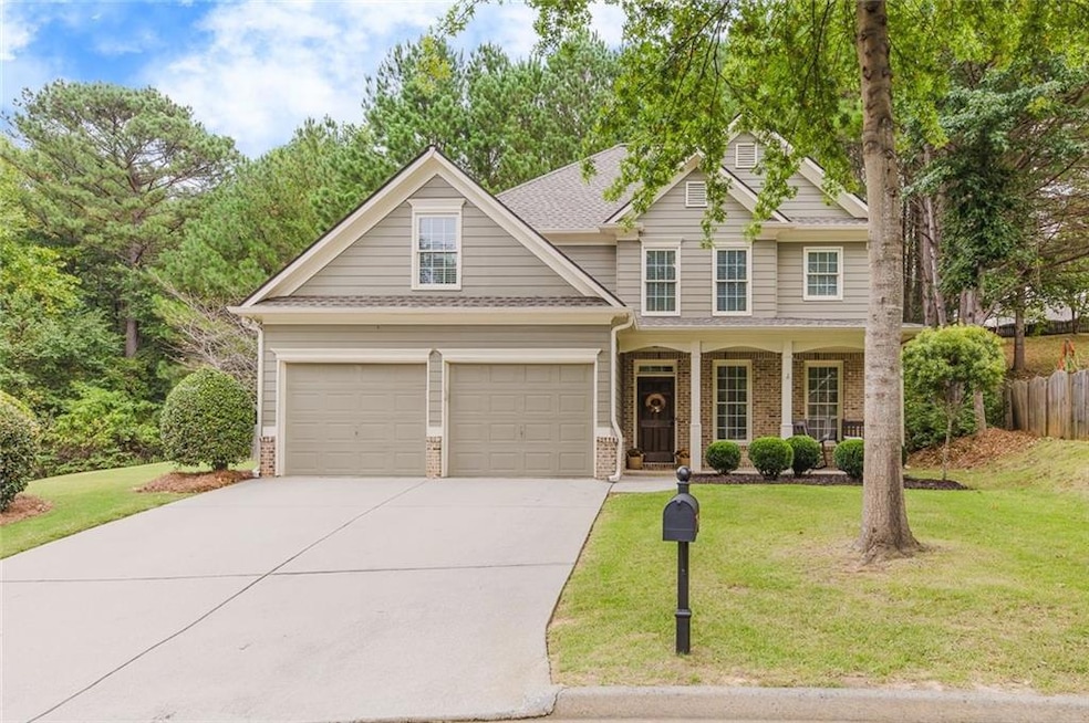 Craftsman-style home with a front lawn, a garage, 