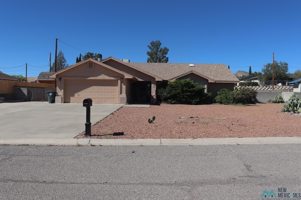 Ranch-style home with concrete driveway, an attached garage, and roof with shingles