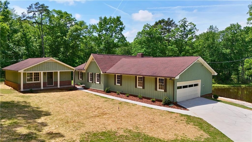 Ranch-style house featuring a garage, a porch, a f