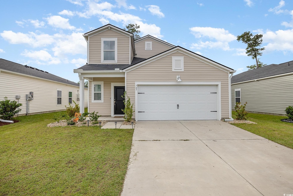 View of front of house featuring a front lawn, con