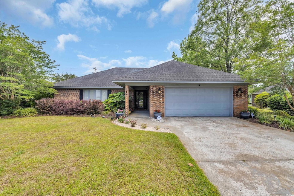 Ranch-style house with driveway, a garage, a shing