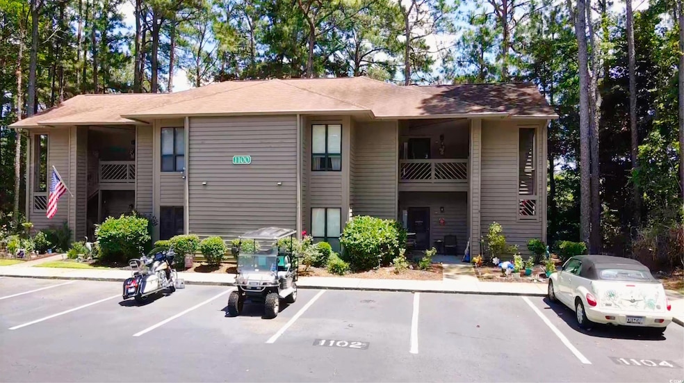 View of property featuring uncovered parking