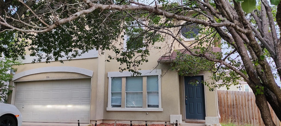 View of front of home with a garage, stucco sidin