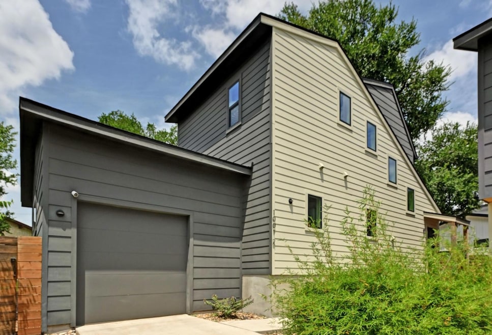 View of home's exterior with driveway and a garage