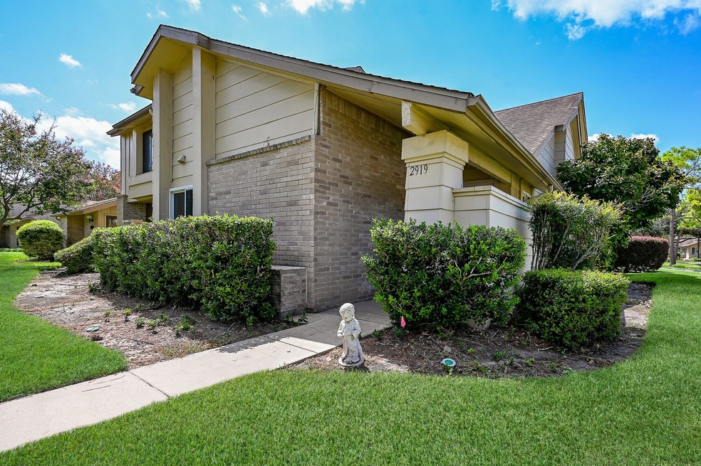 This is a two-story corner townhouse with brick an