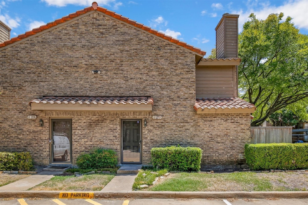Mediterranean / spanish-style house with a tiled roof, a chimney, and brick siding