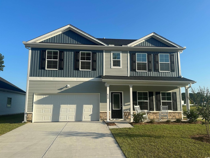 View of front of house featuring a porch, a garage