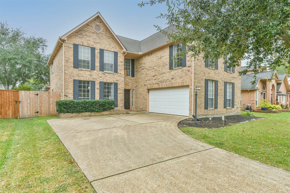 Welcome to 1210 Woodchase Drive in East Pearland's Sunset Meadows community! This 1991-built two-story home showcases a brick elevation, charming shutters, mature trees, and five generously sized bedrooms.
