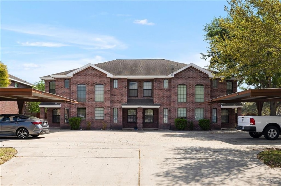 View of front of home with brick siding and covered parking