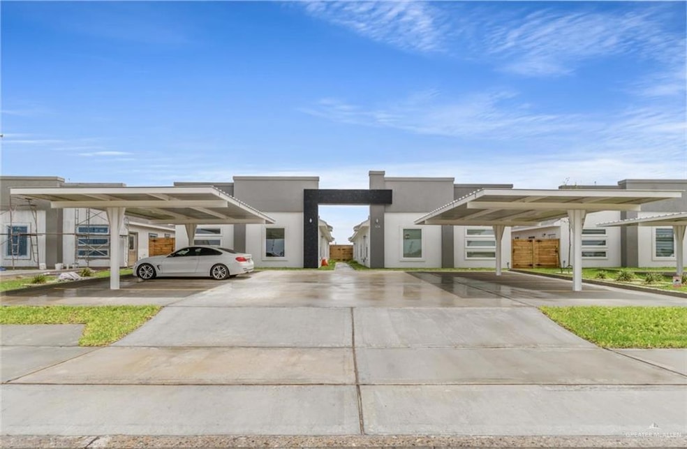 View of front of house with covered parking and stucco siding