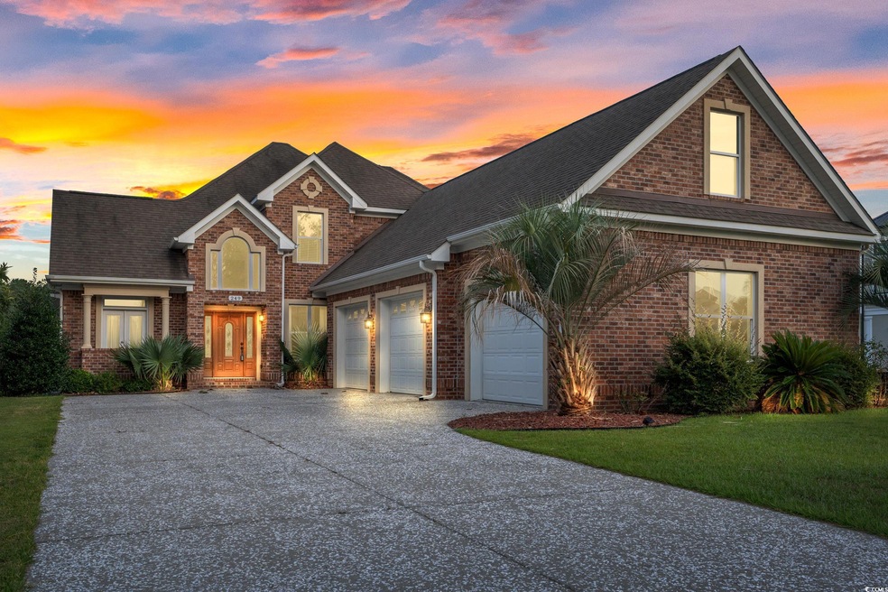 View of front of property with a garage and a lawn