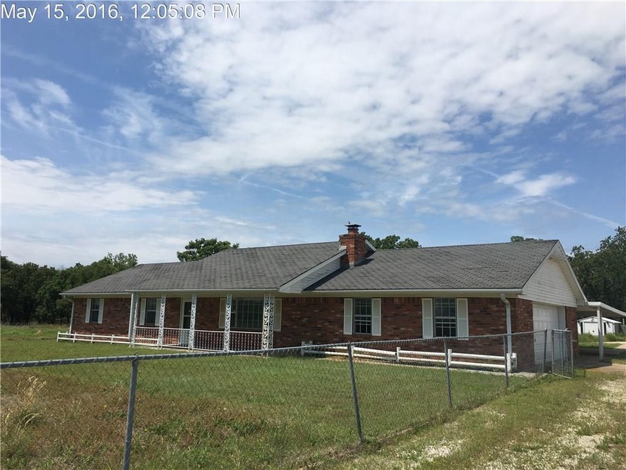 Large covered front porch.  Chain link fencing aro