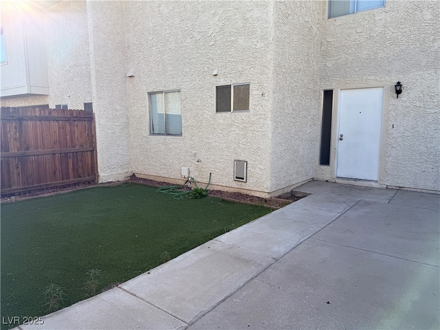 View of side of home featuring stucco siding and a patio area