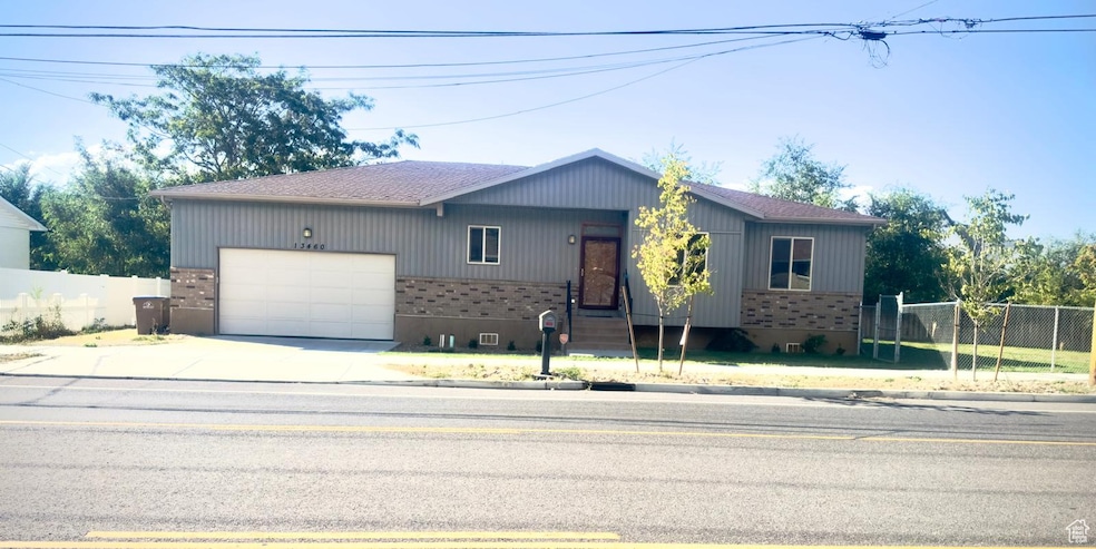 Ranch-style house with brick siding, concrete driveway, roof with shingles, and an attached garage