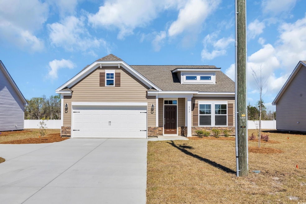 Craftsman-style home with stone siding, a shingled