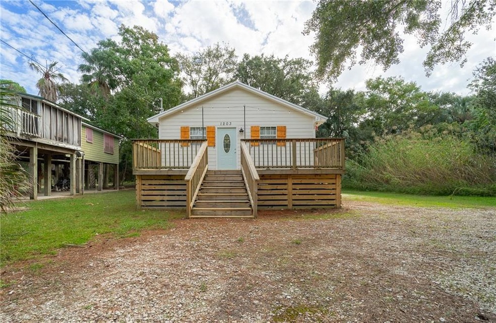 View of front of property featuring a wooden deck