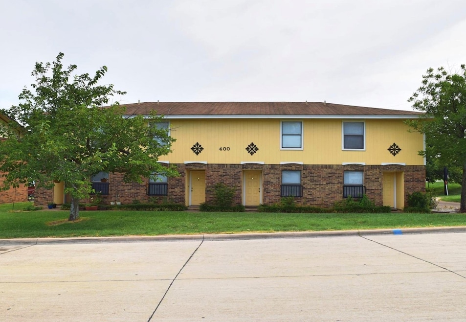 View of front of home with a front lawn and brick siding