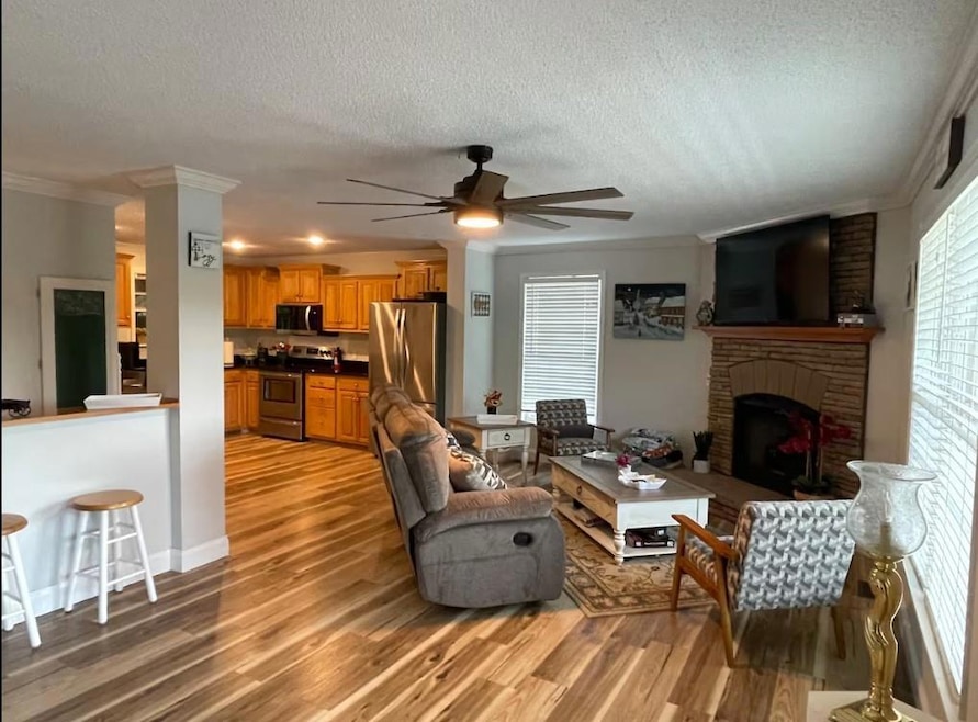 Living room with a textured ceiling, ceiling fan, 