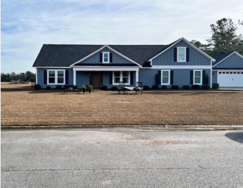 Craftsman-style house with a garage and board and 