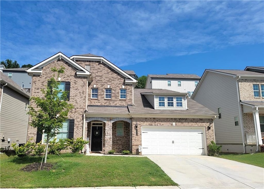 Traditional home featuring roof with shingles, a f