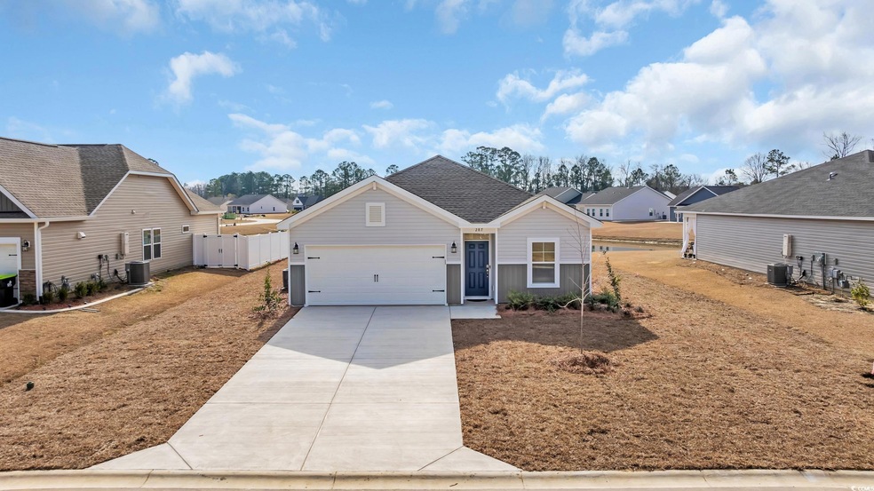 View of front of house featuring driveway, fence, 
