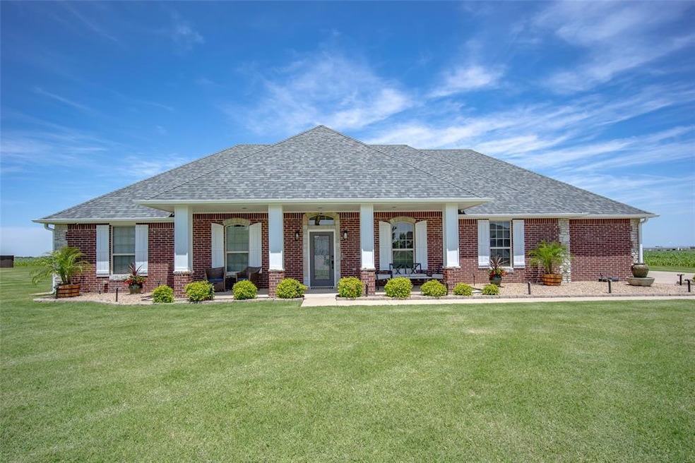 View of front of home with a shingled roof, covere