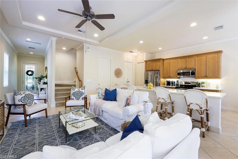 Living room featuring tile patterned floors, crown