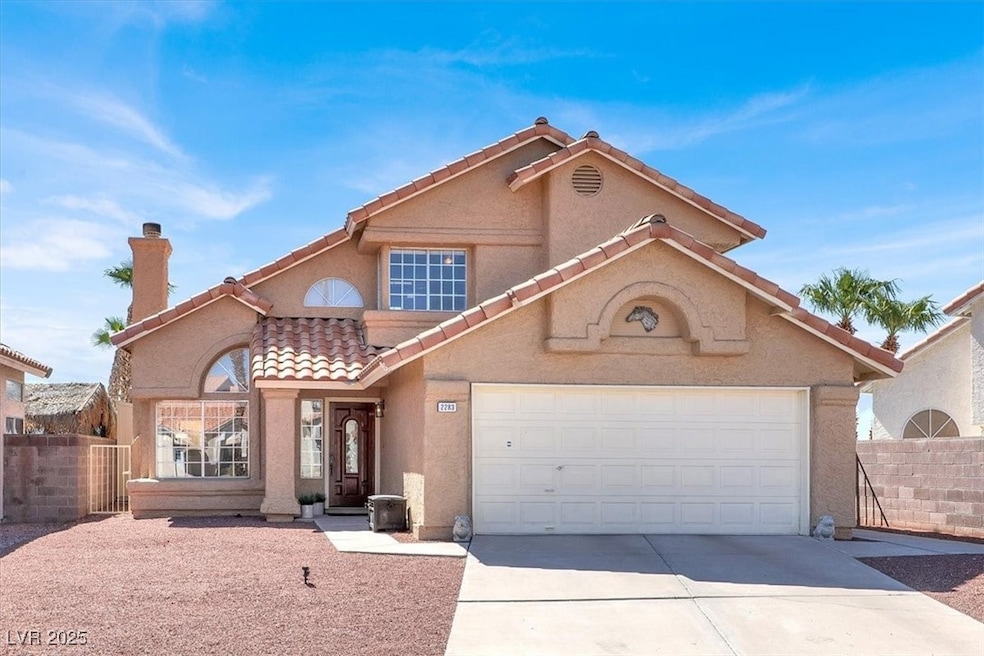 Mediterranean / Spanish-style house with a tile roof, stucco siding, concrete driveway, a chimney, and a 2 car garage