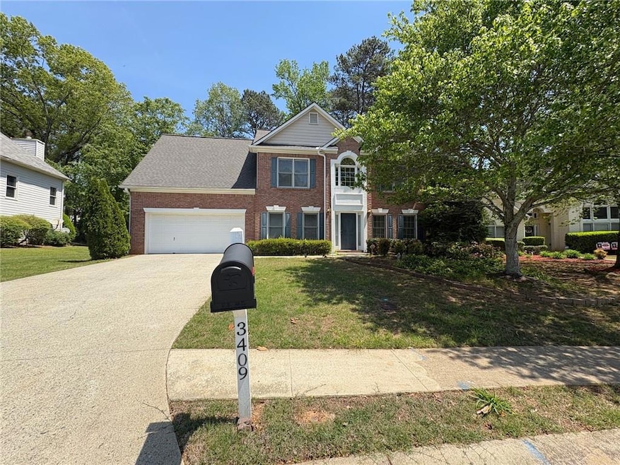 View of front of house with brick siding, a garage
