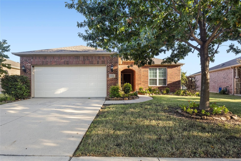 View of front of home with a garage and a front la