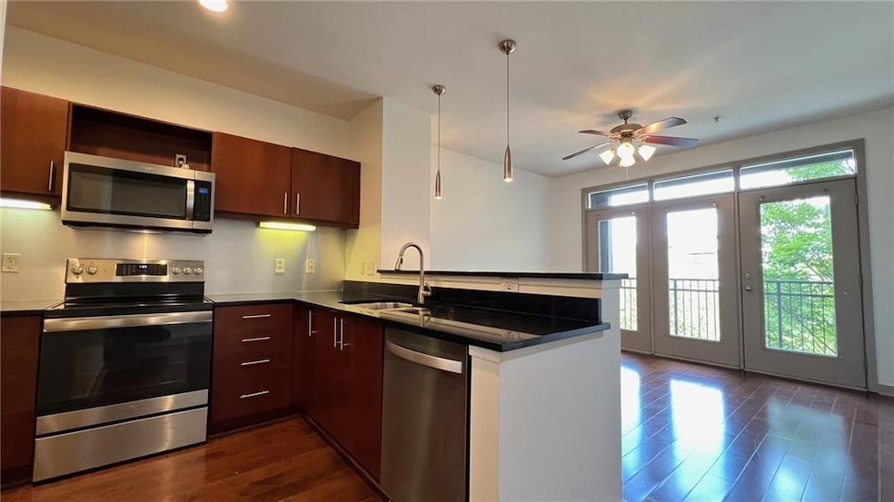 Kitchen with a peninsula, ceiling fan, stainless s
