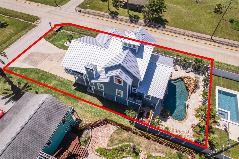 This two-story home features a metal roof and boas