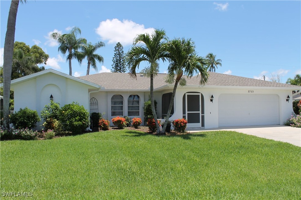 Ranch-style house with a front yard and a garage